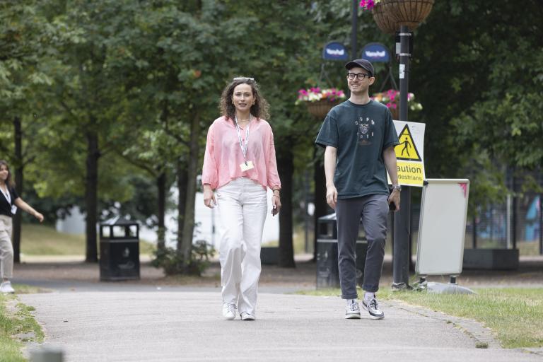Man and woman walking in an urban park