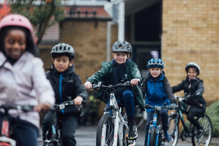 Children cycling in a line