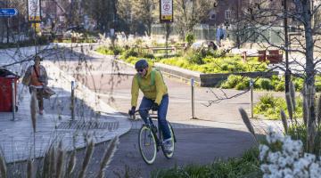 A man cycles along a stretch of segregated cycle lane