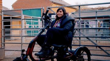 Young woman smiling on a stationary recumbent trike